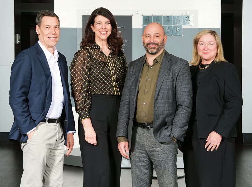 A group of employees sitting around a conference room table