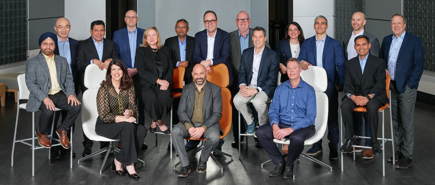 A group of employees sitting around a conference room table